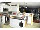 Well-lit kitchen with white cabinets, stainless steel appliances, island, and a decorative backsplash at 3824 Smith Creek Ct, Buford, GA 30519