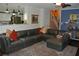 Open concept living room with a large sectional and kitchen access, perfect for entertaining at 3824 Smith Creek Ct, Buford, GA 30519