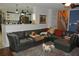 Living room featuring a large sectional, hardwood floors, and access to the kitchen at 3824 Smith Creek Ct, Buford, GA 30519