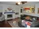 Comfortable living room with a fireplace, leather sectional, and views into the bright kitchen at 3824 Smith Creek Ct, Buford, GA 30519