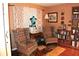 Warm sitting area with armchairs, neutral walls, decorative curtains, and hardwood flooring at 3824 Smith Creek Ct, Buford, GA 30519