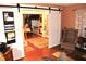 Comfortable living space featuring hardwood floors, a sliding barn door, and neutral color scheme at 3824 Smith Creek Ct, Buford, GA 30519