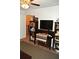 Living room with dark wood bookcase and TV at 3824 Smith Creek Ct, Buford, GA 30519