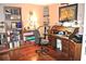 Cozy office with hardwood floors, built-in shelving, and a vintage wooden desk and chair at 3824 Smith Creek Ct, Buford, GA 30519