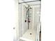 A shower featuring a gray subway tile surround and a modern rainfall showerhead at 3824 Smith Creek Ct, Buford, GA 30519