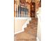 Carpeted staircase with white spindles leading to the upper level of the home at 3824 Smith Creek Ct, Buford, GA 30519