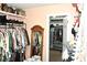 A spacious walk-in closet with custom shelving and hanging rods for clothing and accessory storage at 3824 Smith Creek Ct, Buford, GA 30519