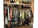 Walk-in closet featuring multiple tiers of hanging rods and shelving for optimal storage at 3824 Smith Creek Ct, Buford, GA 30519