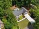 Aerial view of a home surrounded by lush trees and landscaping, with a long driveway at 4249 Arbor Club Dr, Marietta, GA 30066