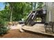 Beautiful backyard with mature trees, a stone patio, and a relaxing hot tub for outdoor enjoyment at 4249 Arbor Club Dr, Marietta, GA 30066