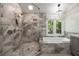 Elegant bathroom showcasing a glass-enclosed shower and a luxurious soaking tub with a large window at 4249 Arbor Club Dr, Marietta, GA 30066