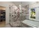 A lavish bathroom showcasing a glass shower and soaking tub situated next to a large walk-in closet at 4249 Arbor Club Dr, Marietta, GA 30066