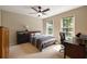 Bedroom with a ceiling fan, carpet, and two large windows providing ample natural light at 4249 Arbor Club Dr, Marietta, GA 30066