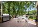 Outdoor deck area with BBQ grill, table, chairs, and lush greenery views, ideal for outdoor dining at 4249 Arbor Club Dr, Marietta, GA 30066