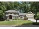Charming two-story home with beautifully landscaped front yard, complemented by an attached two-car garage at 4249 Arbor Club Dr, Marietta, GA 30066