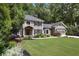 Lovely home featuring a manicured lawn, mature trees, and an attached two-car garage at 4249 Arbor Club Dr, Marietta, GA 30066