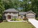 Charming two-story home with a well-manicured lawn, lush landscaping and a two car garage at 4249 Arbor Club Dr, Marietta, GA 30066