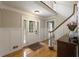 Bright foyer with hardwood floors, staircase, paneled walls and leaded glass front door at 4249 Arbor Club Dr, Marietta, GA 30066