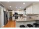 Bright kitchen features granite countertops, stainless appliances, white cabinets, and hardwood floors at 4249 Arbor Club Dr, Marietta, GA 30066
