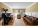 Bright living room featuring hardwood floors, piano, wainscoting, and large windows at 4249 Arbor Club Dr, Marietta, GA 30066