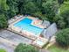A large neighborhood pool featuring a separate kiddie pool, lounge chairs, and mature trees at 4249 Arbor Club Dr, Marietta, GA 30066