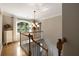 Bright staircase with a chandelier and large window offering views at 4249 Arbor Club Dr, Marietta, GA 30066