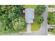 Aerial view of a house with a gray roof surrounded by mature green trees and a long driveway at 536 Cherokee Overlook Court Ct, Canton, GA 30115