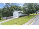 Side view of home featuring a two car garage, green lawn, and mature trees at 536 Cherokee Overlook Court Ct, Canton, GA 30115