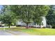 Street view of charming home with mature trees, green lawn, and welcoming front porch at 536 Cherokee Overlook Court Ct, Canton, GA 30115