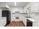 Updated kitchen with stainless steel appliances, white cabinets, and vinyl flooring at 536 Cherokee Overlook Court Ct, Canton, GA 30115