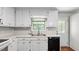 Efficient kitchen with white countertops, black dishwasher, and abundant cabinet space at 536 Cherokee Overlook Court Ct, Canton, GA 30115