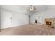 Spacious living room with neutral carpet, stone fireplace and ceiling fan, perfect for gatherings at 536 Cherokee Overlook Court Ct, Canton, GA 30115
