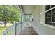 A charming front porch with wooden floors and railings, a perfect spot for relaxing at 536 Cherokee Overlook Court Ct, Canton, GA 30115