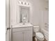 Bright bathroom with a white vanity, toilet, and a shower-tub combo at 609 Elsa Lane Lot 76, Mcdonough, GA 30252