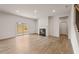 Bright living room with wood floors, fireplace, sliding glass doors, and staircase access at 609 Elsa Lane Lot 76, Mcdonough, GA 30252