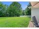 Spacious backyard featuring mature trees, a shed, and a white fence, creating a private and inviting outdoor space at 145 Deep Step Rd, Covington, GA 30014