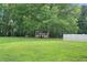 Expansive backyard with mature trees and a shed, perfect for outdoor activities and storage at 145 Deep Step Rd, Covington, GA 30014