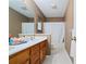 Bathroom with white countertop, wood cabinets, large mirror, and shower with white tile at 145 Deep Step Rd, Covington, GA 30014
