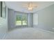 A bedroom with carpeted floor, ceiling fan, and windows providing natural light at 145 Deep Step Rd, Covington, GA 30014