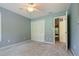 A bedroom with carpeted floor, ceiling fan, closet, and windows providing natural light at 145 Deep Step Rd, Covington, GA 30014