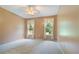 A bedroom with carpeted floor, ceiling fan, and two windows allowing natural light at 145 Deep Step Rd, Covington, GA 30014