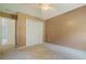 A bedroom with carpeted floor, ceiling fan, and closet with louvered doors at 145 Deep Step Rd, Covington, GA 30014