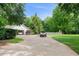 Long concrete driveway leading to a detached garage, with ample parking space for multiple vehicles at 145 Deep Step Rd, Covington, GA 30014
