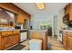 Functional kitchen with wood cabinets, stainless steel appliances, and an island workspace at 145 Deep Step Rd, Covington, GA 30014