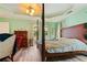 A spacious main bedroom featuring tray ceiling, wood-look floors, and sliding glass door at 145 Deep Step Rd, Covington, GA 30014