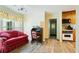 Comfortable sitting area features a red sofa, desk, and built-in oven with view to outdoor scenery at 145 Deep Step Rd, Covington, GA 30014