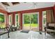Bright sunroom featuring large windows with backyard view and a walkout to a wooden deck at 145 Deep Step Rd, Covington, GA 30014