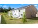 View of a home's exterior with a white fence, healthy lawn, and young trees, showcasing a modern aesthetic at 215 Silver Moon Dr, Loganville, GA 30052
