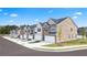 A row of new townhomes featuring attached garages, modern exteriors, and well-maintained landscaping at 215 Silver Moon Dr, Loganville, GA 30052