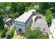 Overhead angle of an attractive three-story home and manicured lawn surrounded by trees at 2972 Lookout Ne Pl, Atlanta, GA 30305